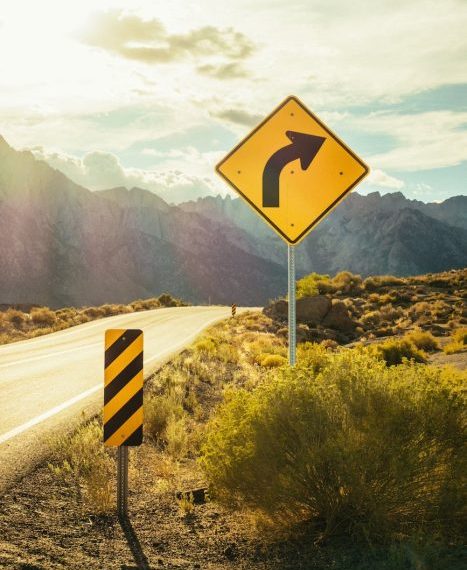 A road sign with an arrow pointing to the right.