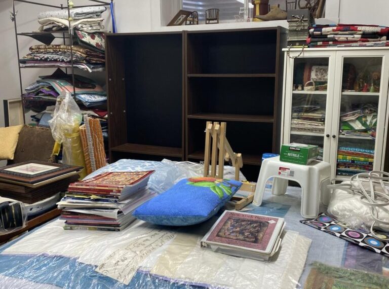 A room with a lot of items on a table.