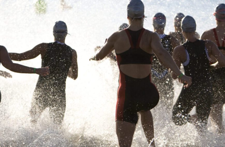 A group of people running in the water.