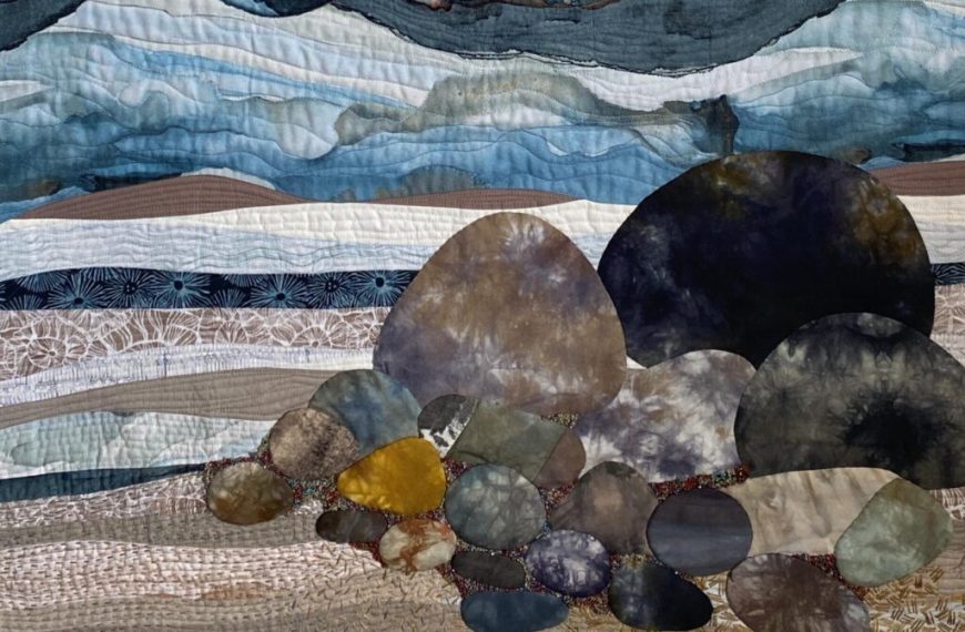 A quilt with rocks and mountains on it.