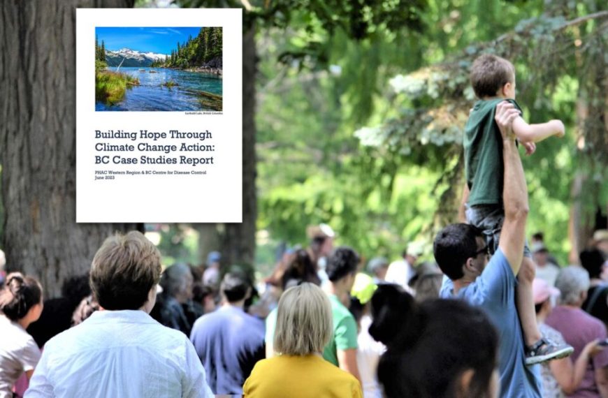 A crowd of people in a park with a picture of a river.