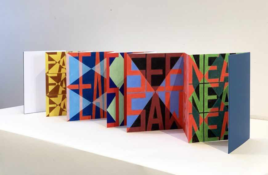 A series of colorful books on a table.