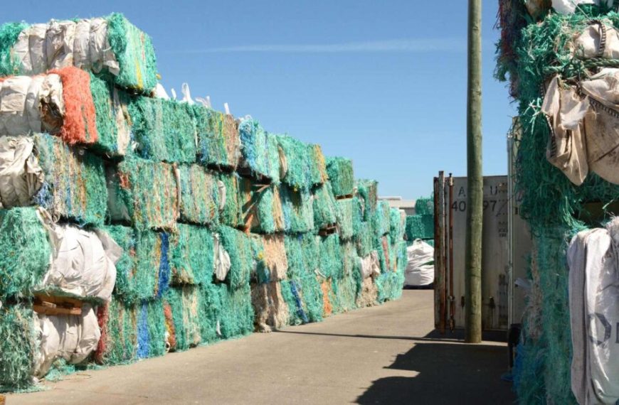 A large pile of fishing nets in a warehouse.