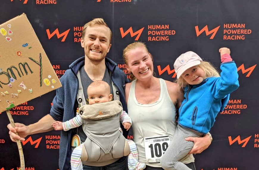 A family holding a sign for the human powered race.