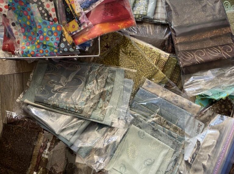 A pile of fabric and other items on a table.