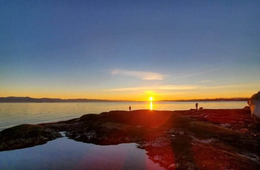 The sun is setting over a body of water.