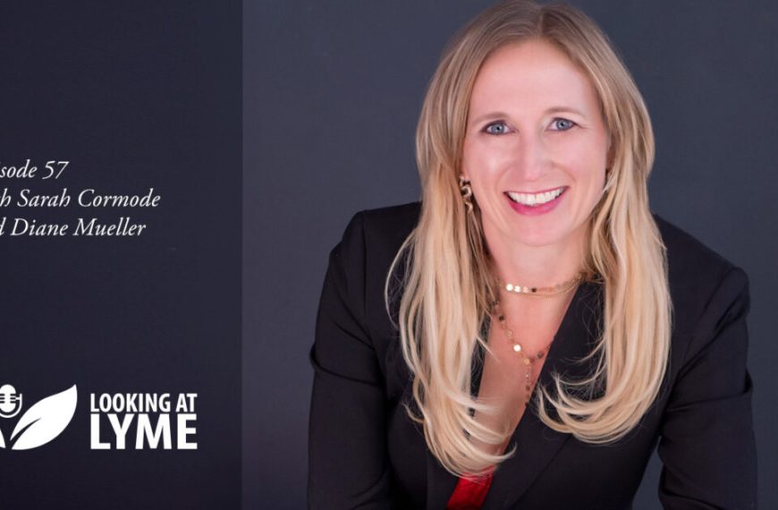A smiling woman in a business suit with the logo of lyme.