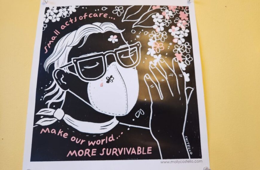 A poster with a picture of a woman wearing a mask.