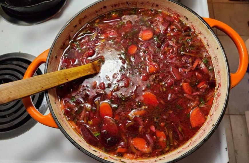 A pot of stew with a wooden spoon in it.