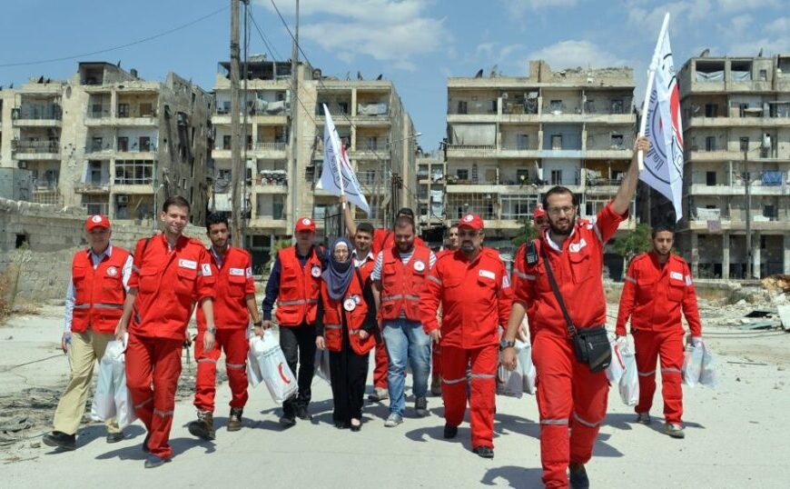 The International Committee of the Red Cross organized a fundraiser with a group of people in red uniforms walking down a street.