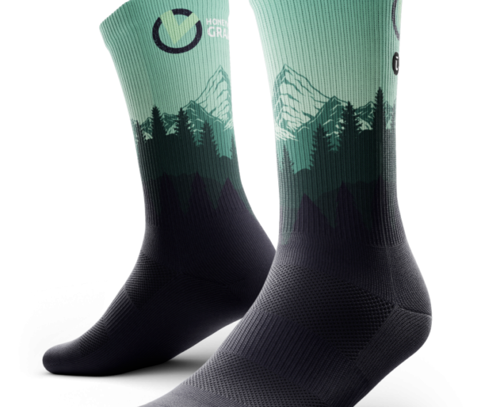A pair of cool socks with mountains and trees on them.
