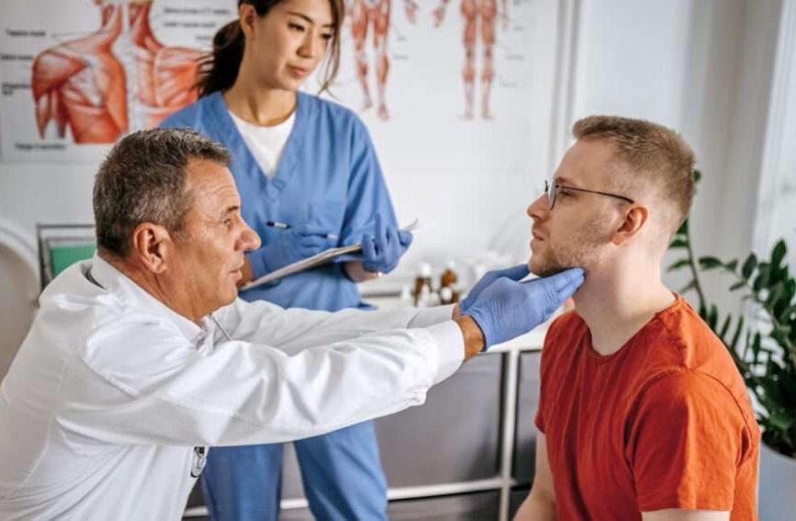 A doctor is examining a patient's neck for chronic symptoms possibly related to Borrelia burgdorferi.