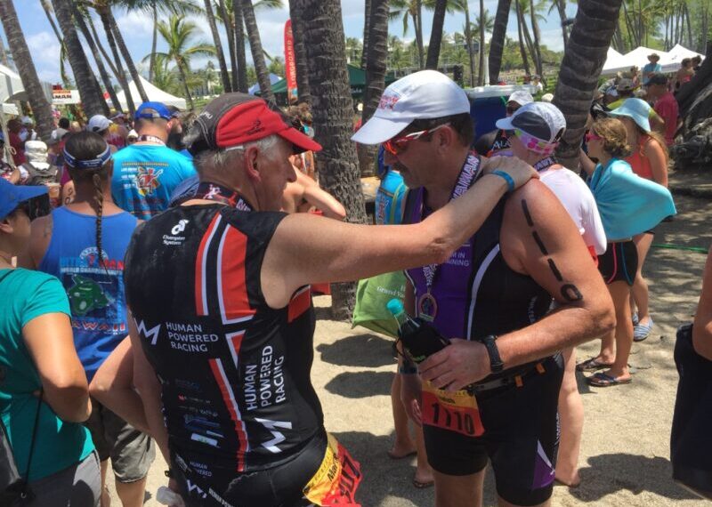 Justin Martin receives the Spirit Award while in a trisuit at a race in 2023.