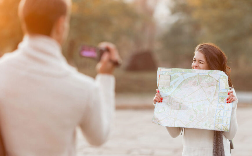 A woman holding a map while planning travel.