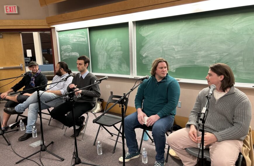 A group of people sitting in chairs at a Men's Wellness Event.