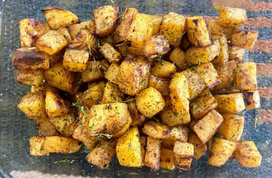 Awesome roasted potatoes in a glass dish with thyme.