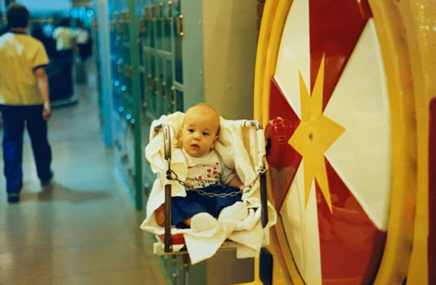 A jade baby sitting in a chair in a hallway.