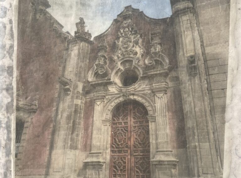 A photograph of a building with a door, showcasing layered elegance.