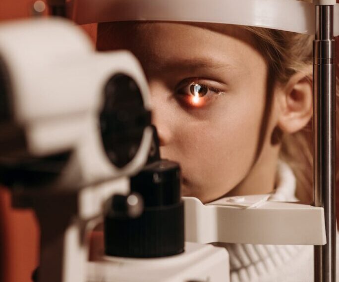 A young girl experiencing vision loss while undergoing an eye exam for possible Lyme neuroborreliosis.