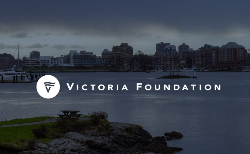 View of a waterfront city skyline at dusk with the Victoria Foundation logo and VCST grant text overlaid in the center.