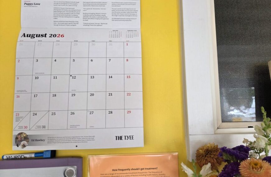 A wall calendar for August 2026 hangs next to a window and a bouquet of flowers, with informational materials—highlighting important policy changes and updated cancellation policies effective Sept 1st—displayed below.